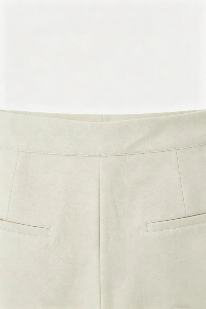 An image of a   10996 Asymmetric Button-Wrap Skirt by  Mirra Masa