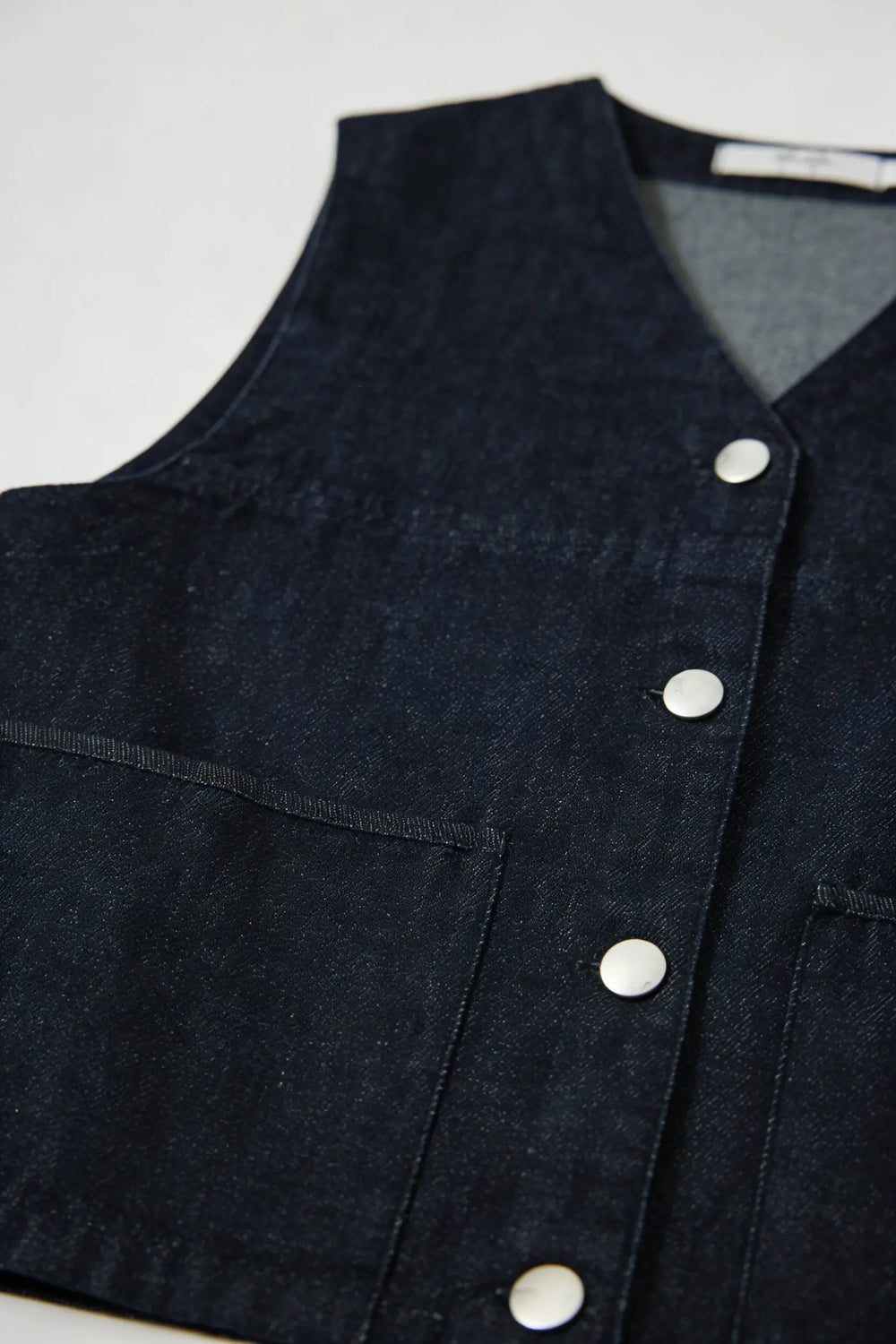 An image of a   11344 Button-Front Denim Vest by  Mirra Masa