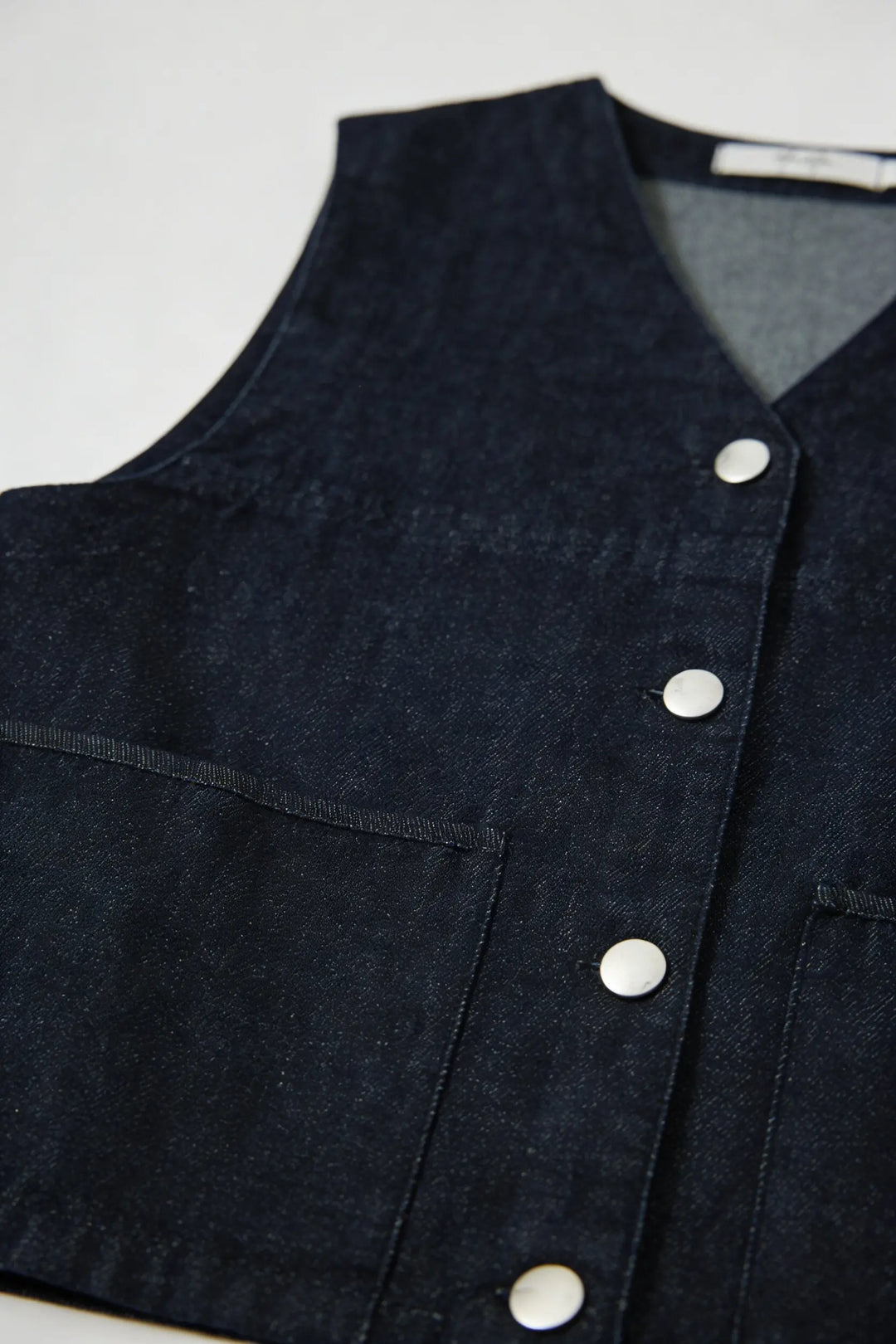 An image of a   11344 Button-Front Denim Vest by  Mirra Masa