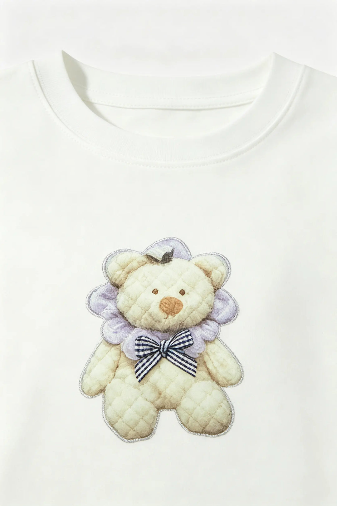 An image of a   21865 Embroidered Teddy Graphic Tee by  Mirra Masa