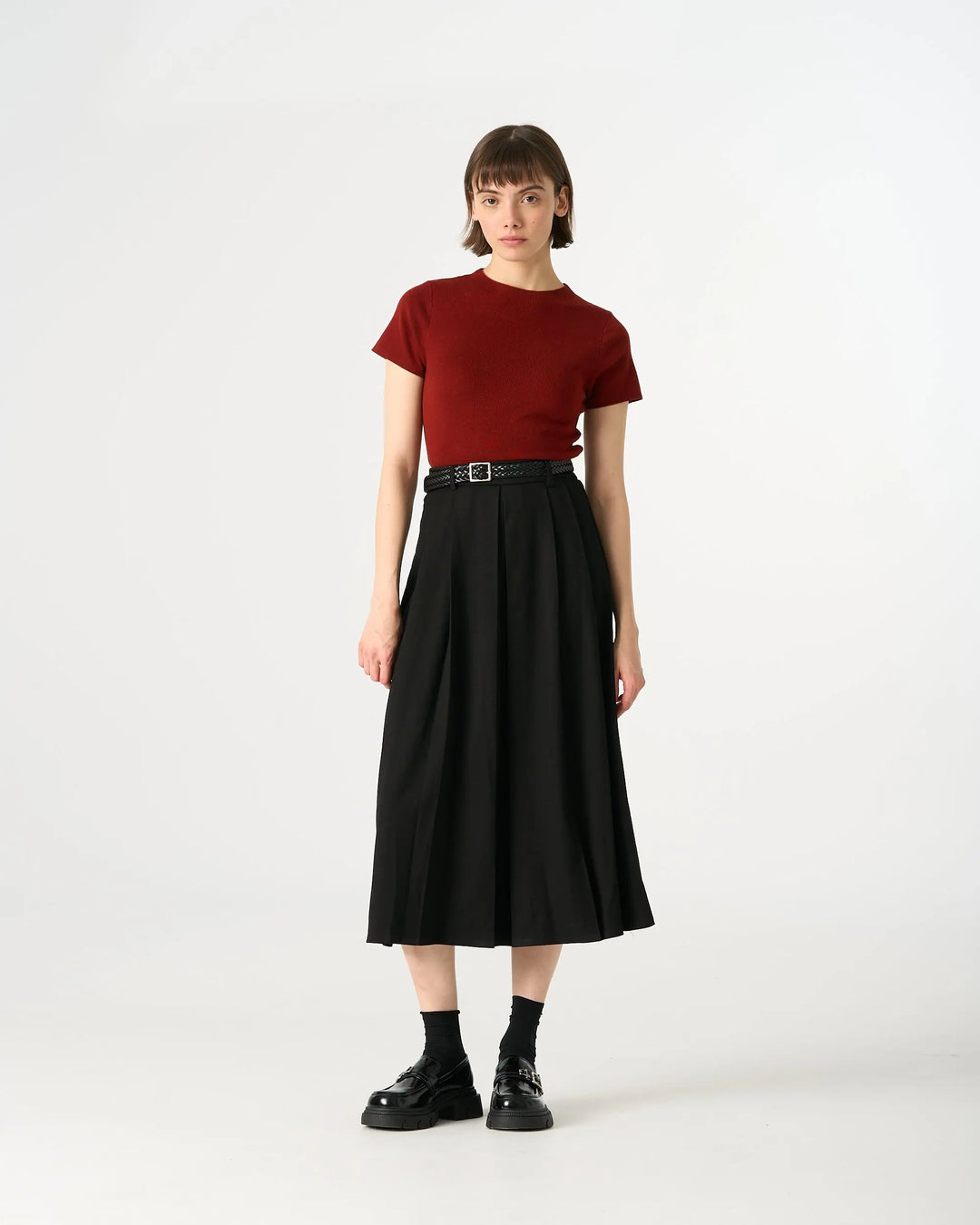 An image of a  Black / Large 32307 Pleated Midi Skirt by  Mirra Masa