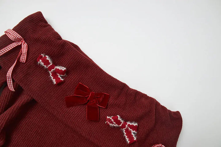 An image of a   41103 Holiday Bow Off Shoulder Top by  Mirra Masa