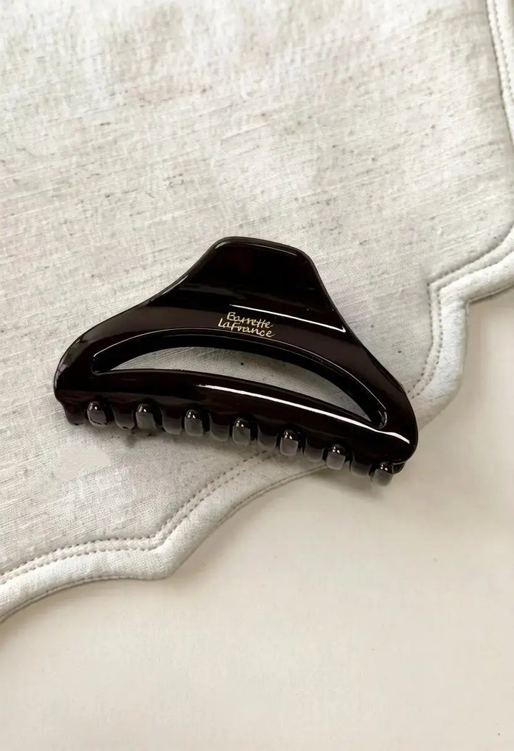 An image of a   Arched Cutout Hair Claw Small by  Mirra Masa
