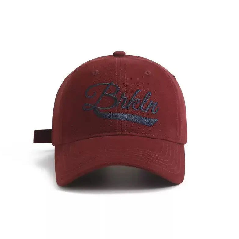 An image of a  Burgundy Red Brooklyn Script Embroidery Cap by  Mirra Masa