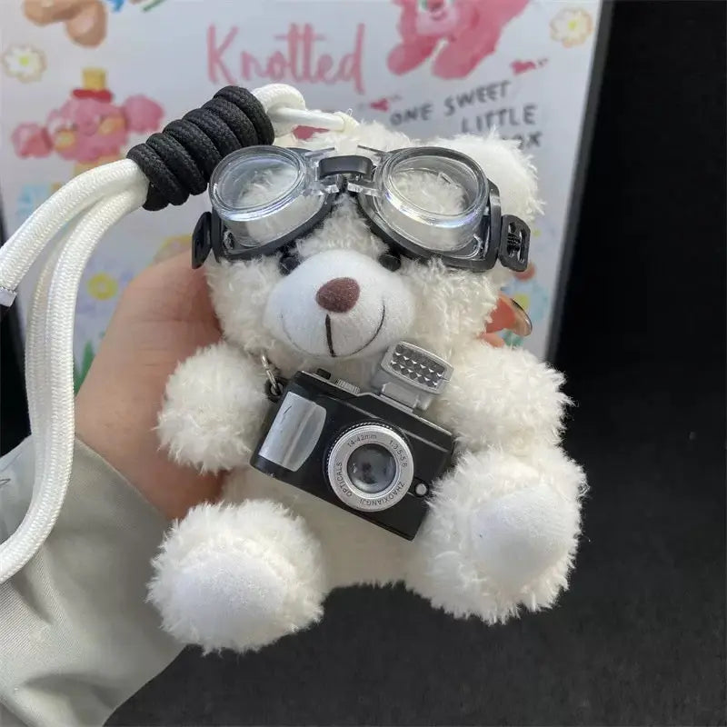 An image of a  White Camera Teddy Plush Bag & Key Charm by  Mirra Masa