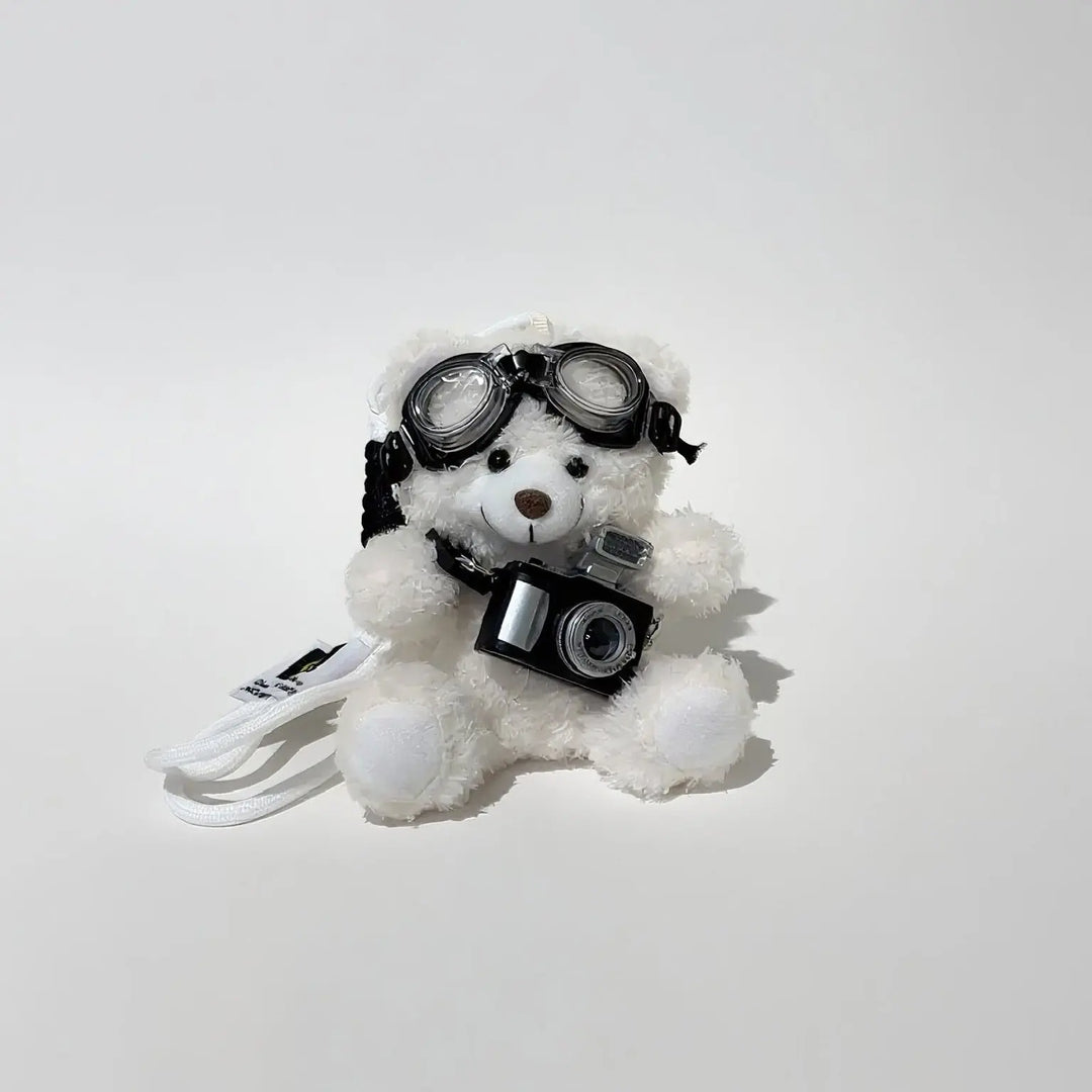 An image of a   Camera Teddy Plush Bag & Key Charm by  Mirra Masa