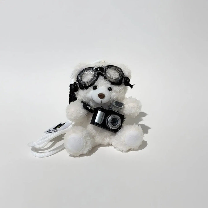 An image of a   Camera Teddy Plush Bag & Key Charm by  Mirra Masa