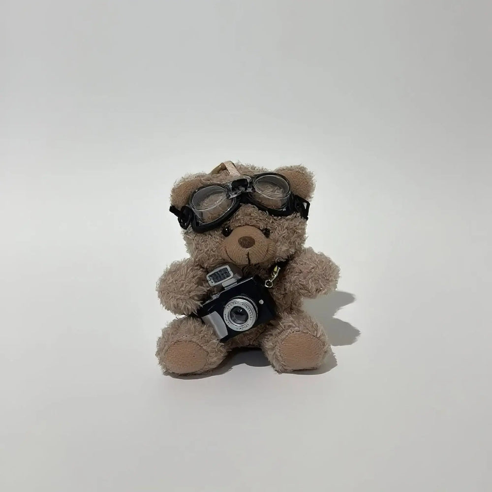 An image of a   Camera Teddy Plush Bag & Key Charm by  Mirra Masa