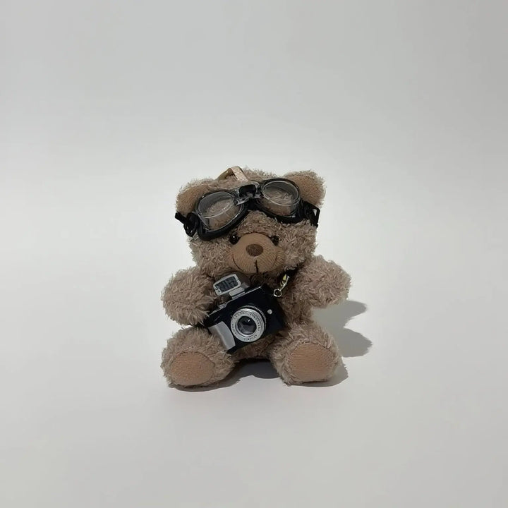 An image of a   Camera Teddy Plush Bag & Key Charm by  Mirra Masa