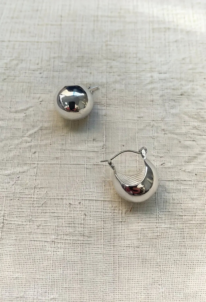 An image of a   Chunky Teardrop Hoop Earrings by  Mirra Masa
