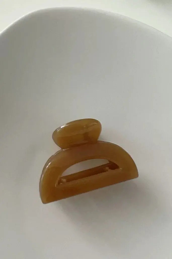 An image of a   Cutout Half-Moon Hair Claw Small by  Mirra Masa