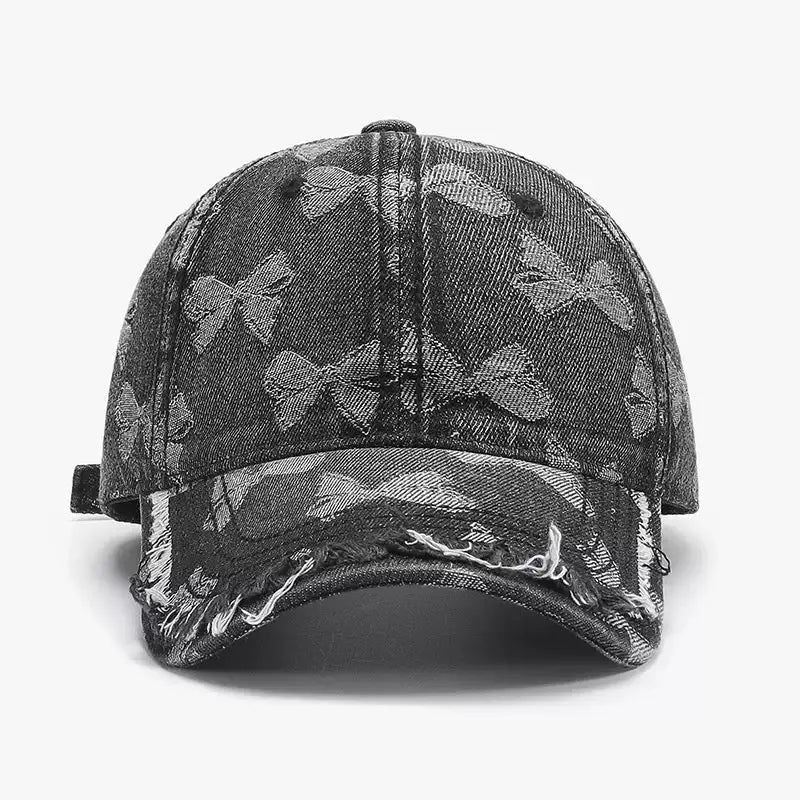 An image of a   Distressed Bow Denim Cap by  Mirra Masa