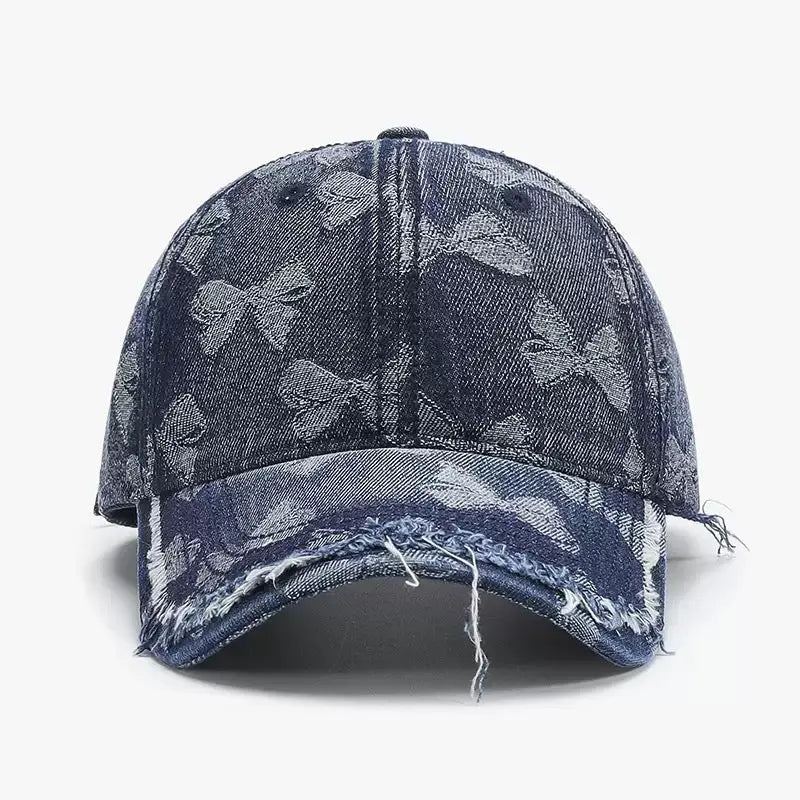 An image of a   Distressed Bow Denim Cap by  Mirra Masa