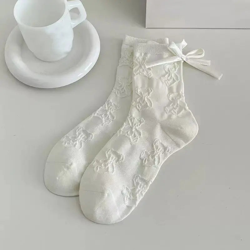 An image of a   Embossed Teddy Bow Socks by  Mirra Masa
