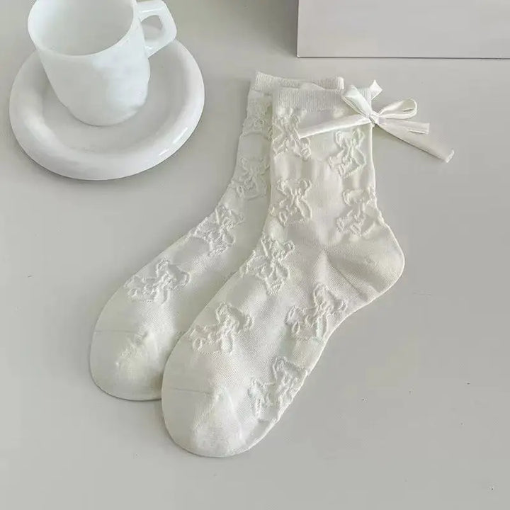 An image of a   Embossed Teddy Bow Socks by  Mirra Masa