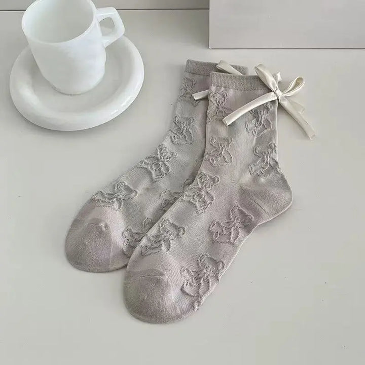 An image of a   Embossed Teddy Bow Socks by  Mirra Masa