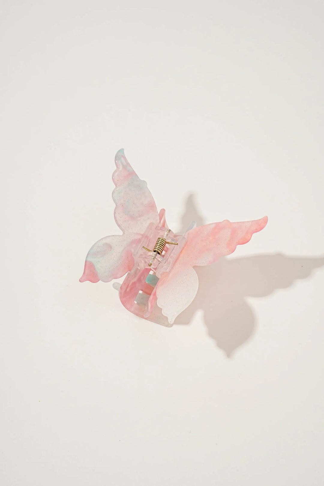 An image of a   Glossy Marbled Butterfly Hair Claw by  Mirra Masa