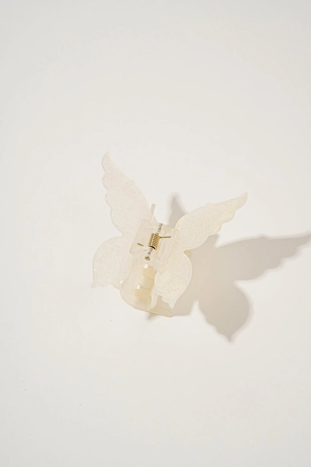 An image of a   Glossy Marbled Butterfly Hair Claw by  Mirra Masa