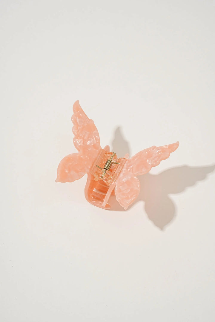 An image of a   Glossy Marbled Butterfly Hair Claw by  Mirra Masa