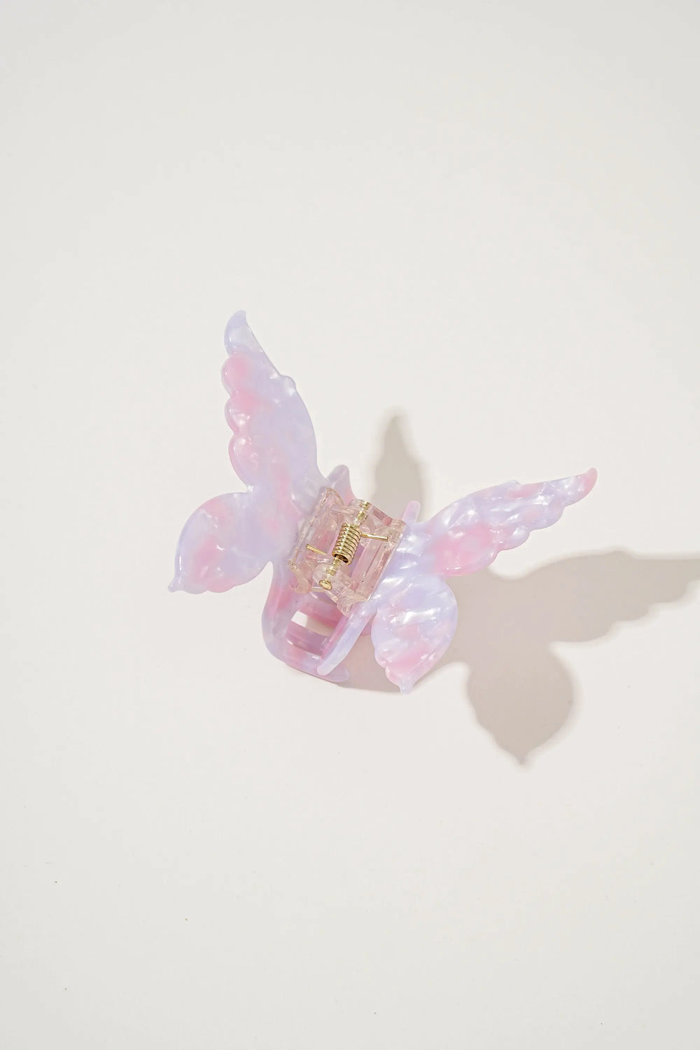 An image of a   Glossy Marbled Butterfly Hair Claw by  Mirra Masa