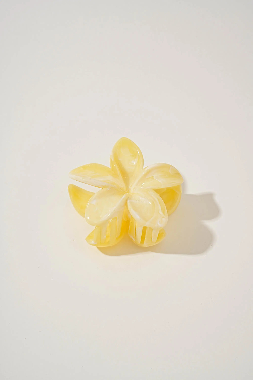 An image of a   Glossy Marbled Flower Hair Claw by  Mirra Masa