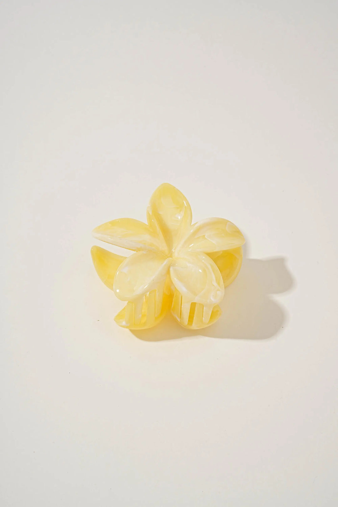 An image of a   Glossy Marbled Flower Hair Claw by  Mirra Masa