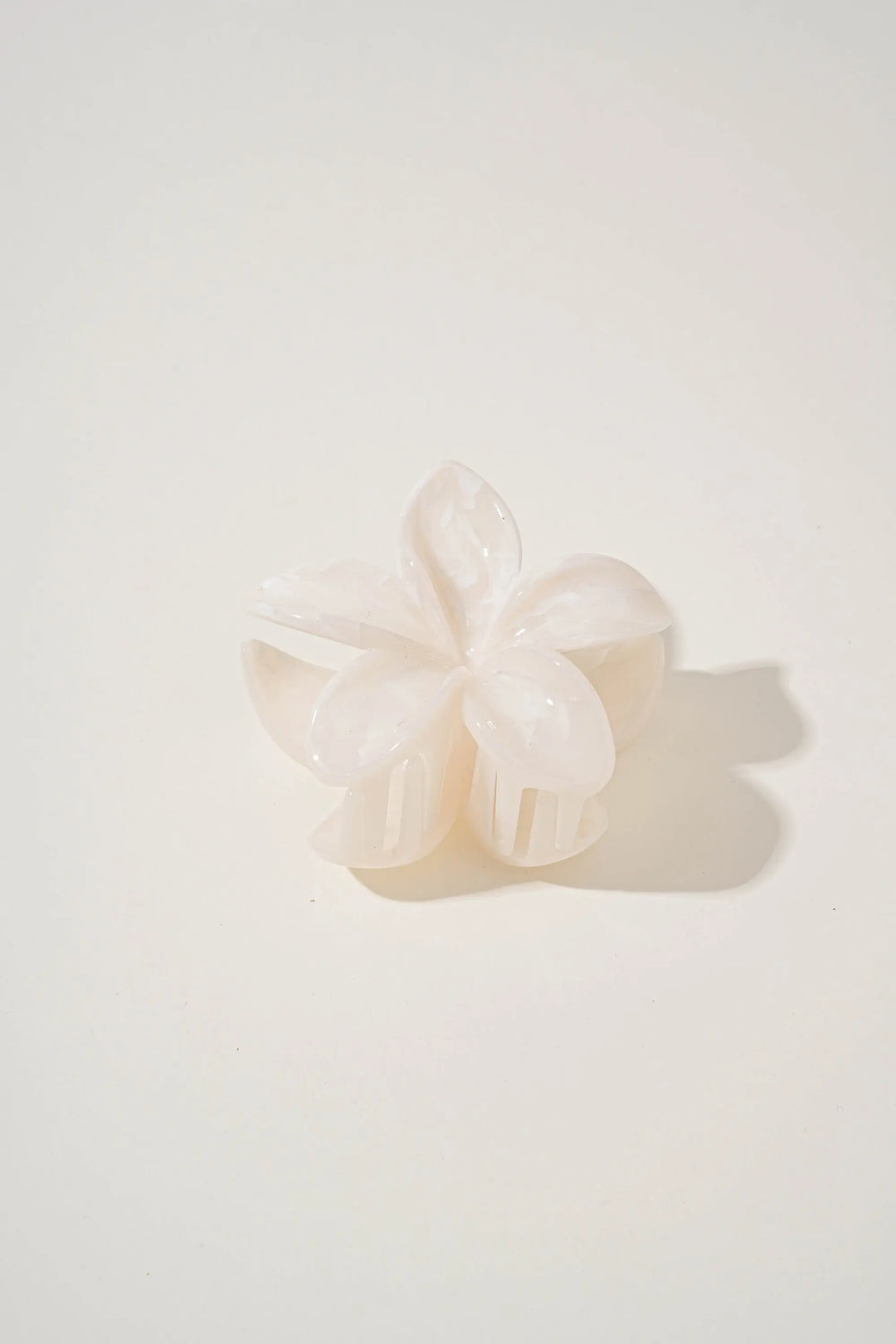 An image of a   Glossy Marbled Flower Hair Claw by  Mirra Masa