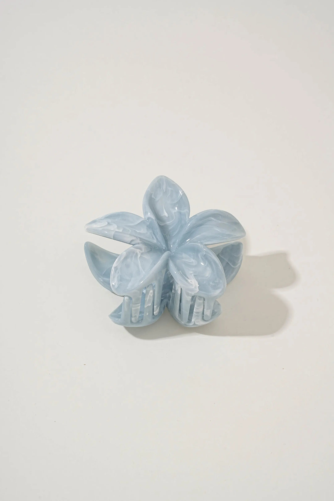 An image of a   Glossy Marbled Flower Hair Claw by  Mirra Masa