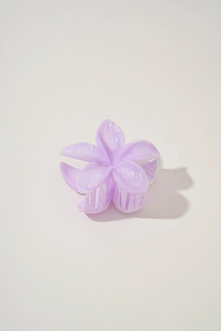 An image of a   Glossy Marbled Flower Hair Claw by  Mirra Masa