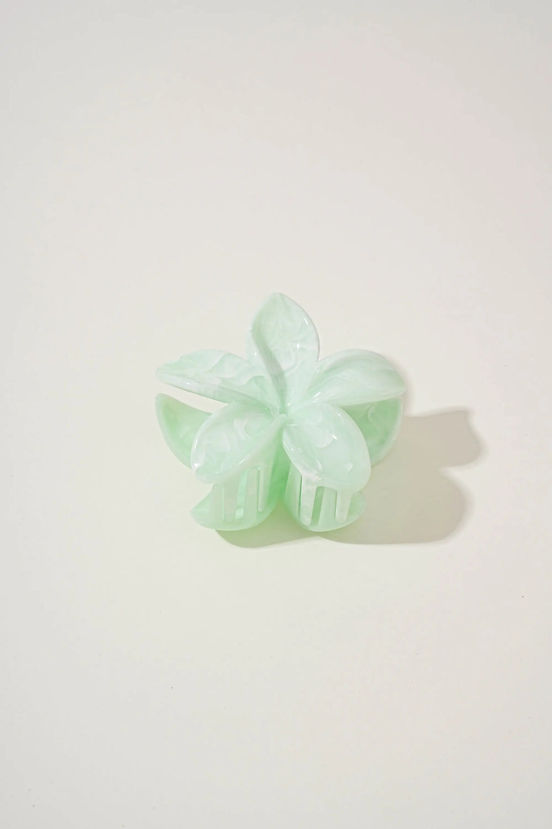 An image of a   Glossy Marbled Flower Hair Claw by  Mirra Masa