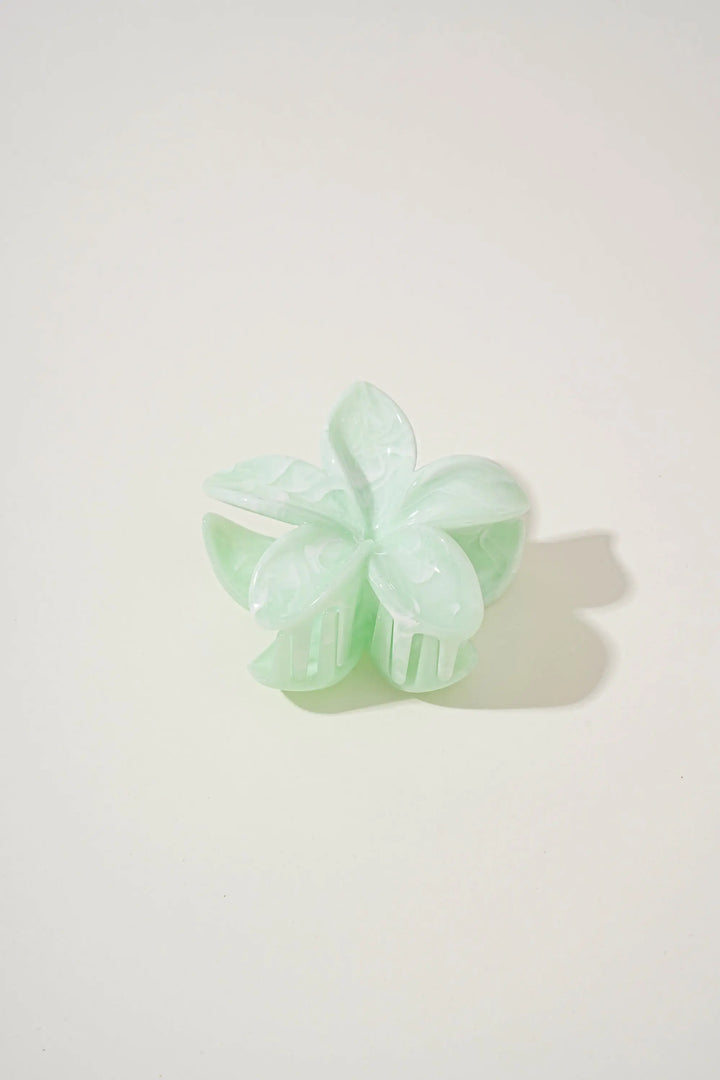 An image of a   Glossy Marbled Flower Hair Claw by  Mirra Masa