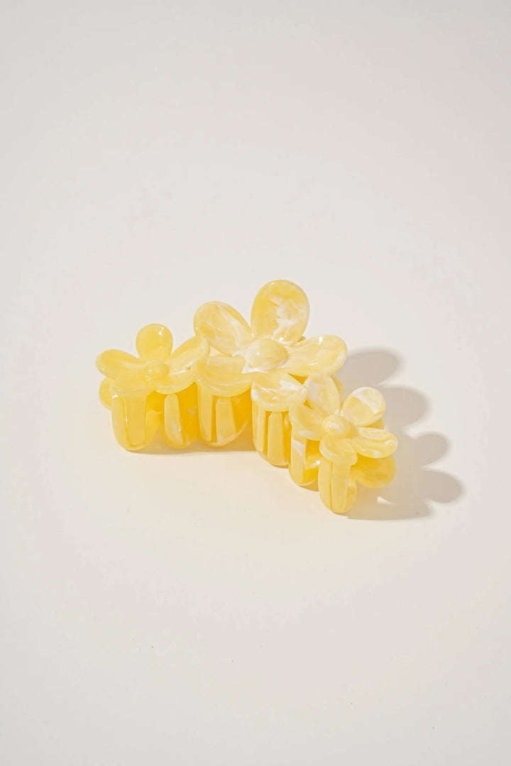 An image of a   Glossy Marbled Trio-Flower Hair Claw by  Mirra Masa