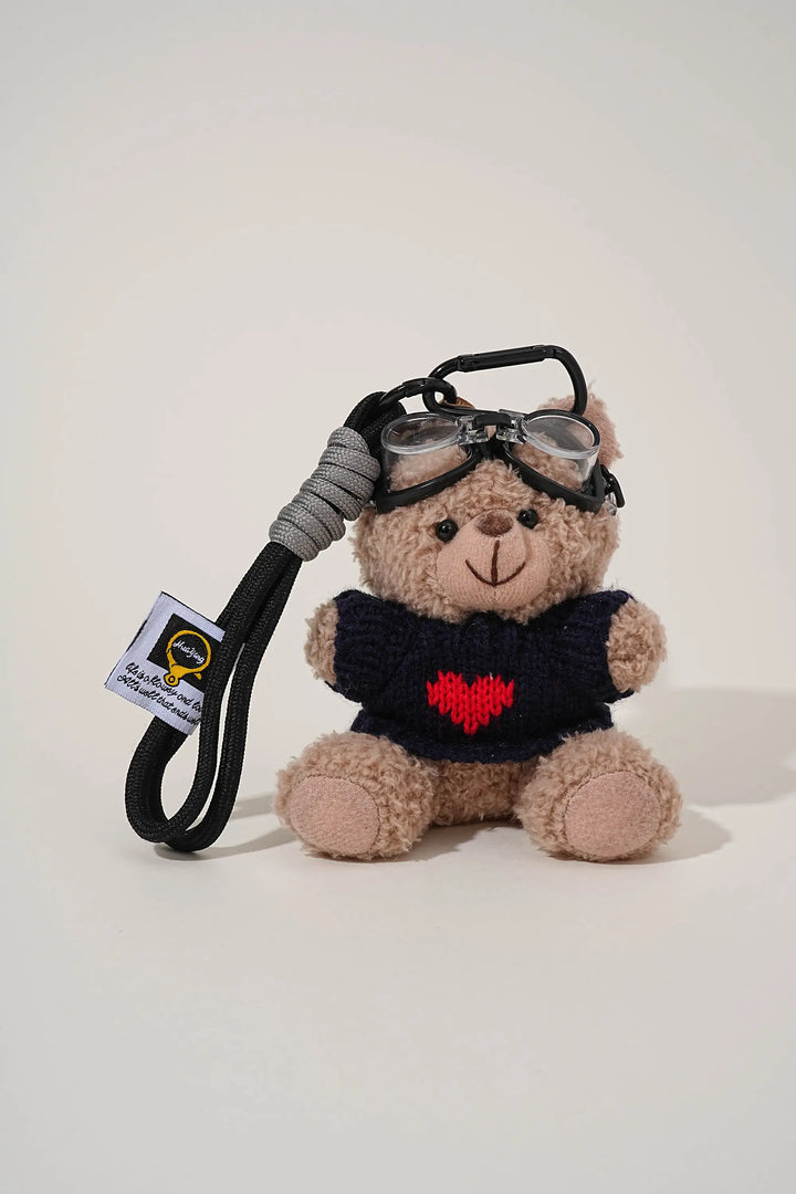 An image of a   Knit Sweater Teddy Bear Bag & Key Charm by  Mirra Masa