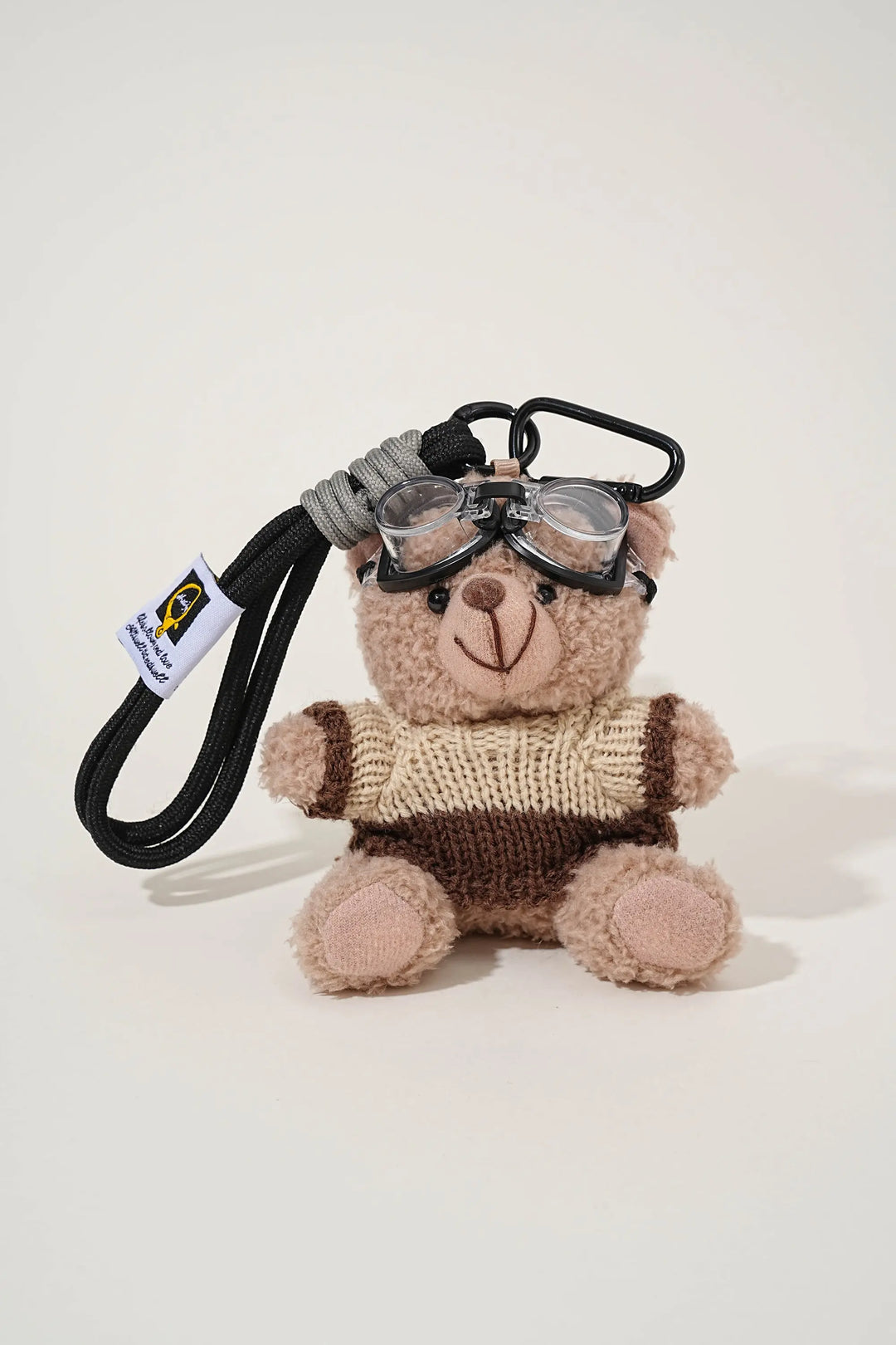 An image of a   Knit Sweater Teddy Bear Bag & Key Charm by  Mirra Masa