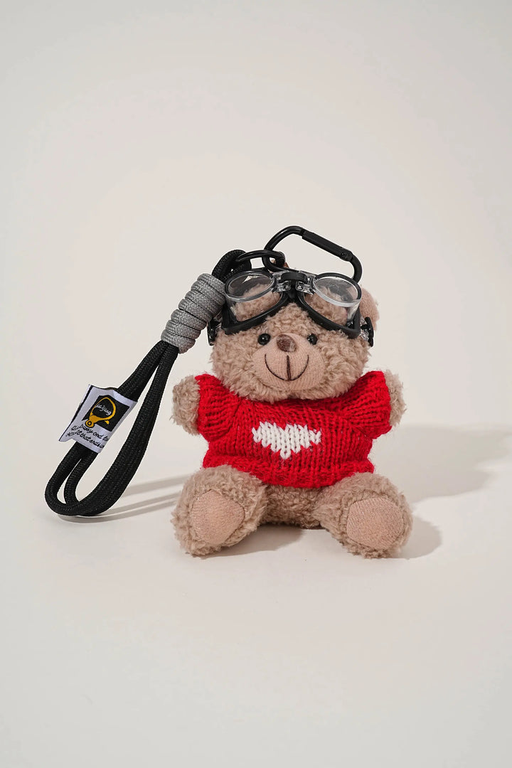 An image of a   Knit Sweater Teddy Bear Bag & Key Charm by  Mirra Masa