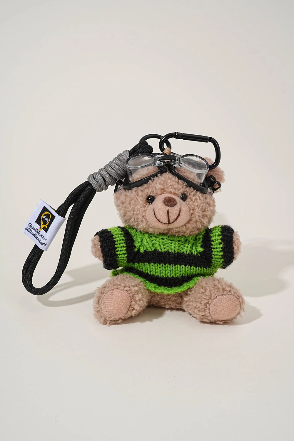 An image of a   Knit Sweater Teddy Bear Bag & Key Charm by  Mirra Masa