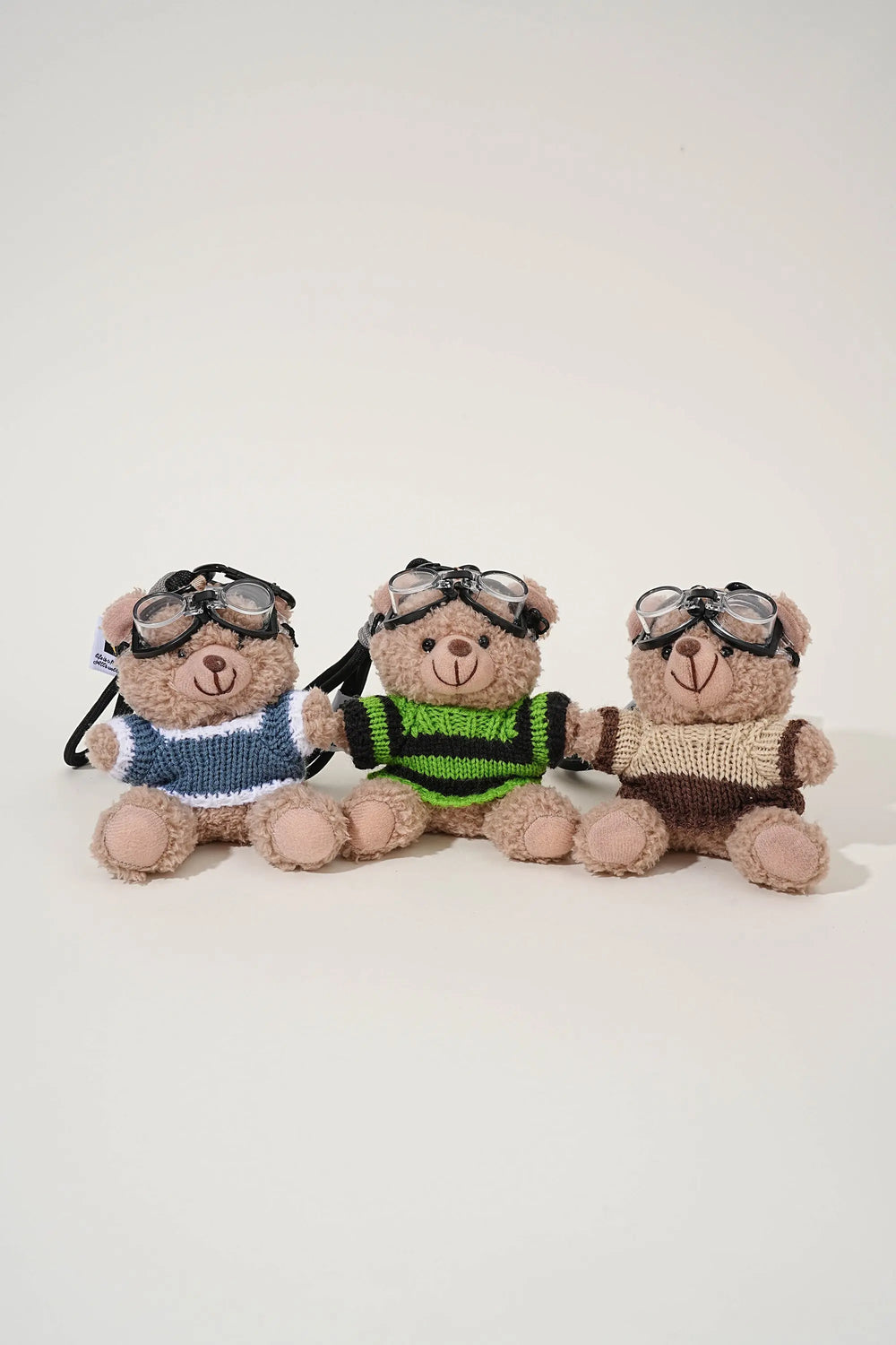 An image of a   Knit Sweater Teddy Bear Bag & Key Charm by  Mirra Masa