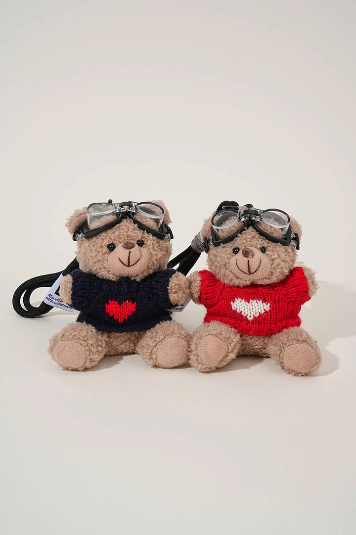 An image of a   Knit Sweater Teddy Bear Bag & Key Charm by  Mirra Masa
