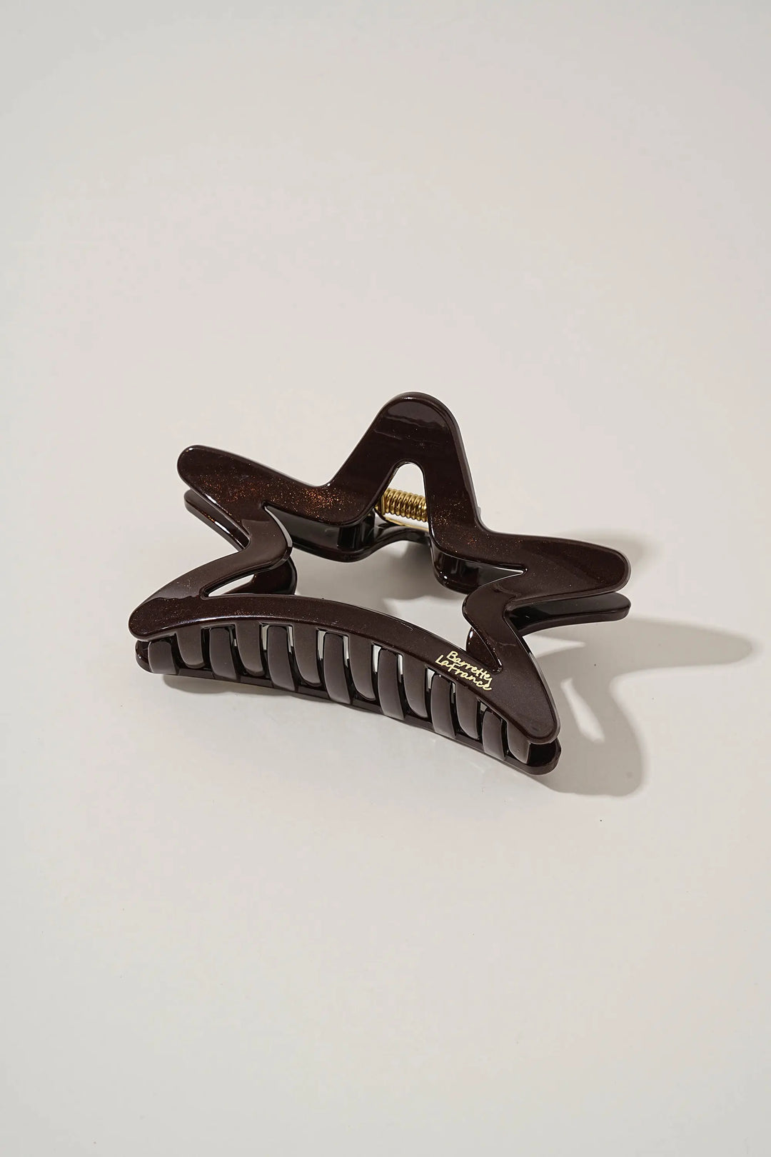 An image of a   Matte Cutout Star Claw by  Mirra Masa