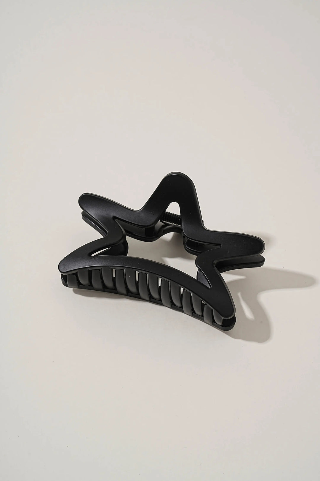 An image of a   Matte Cutout Star Claw by  Mirra Masa