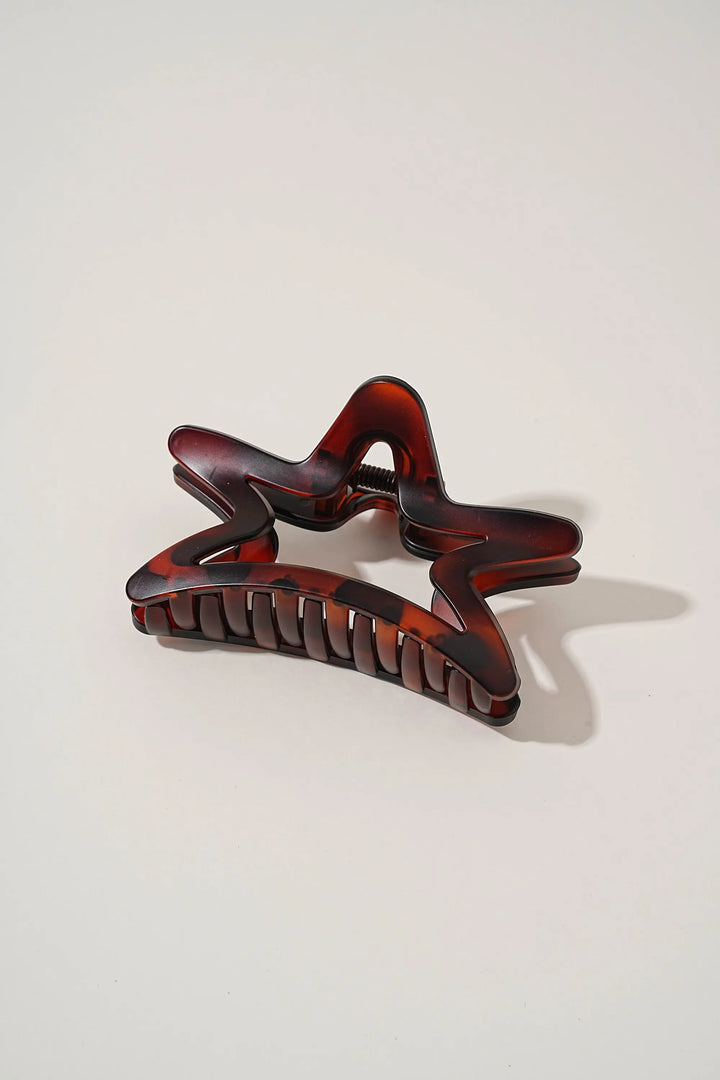An image of a   Matte Cutout Star Claw by  Mirra Masa