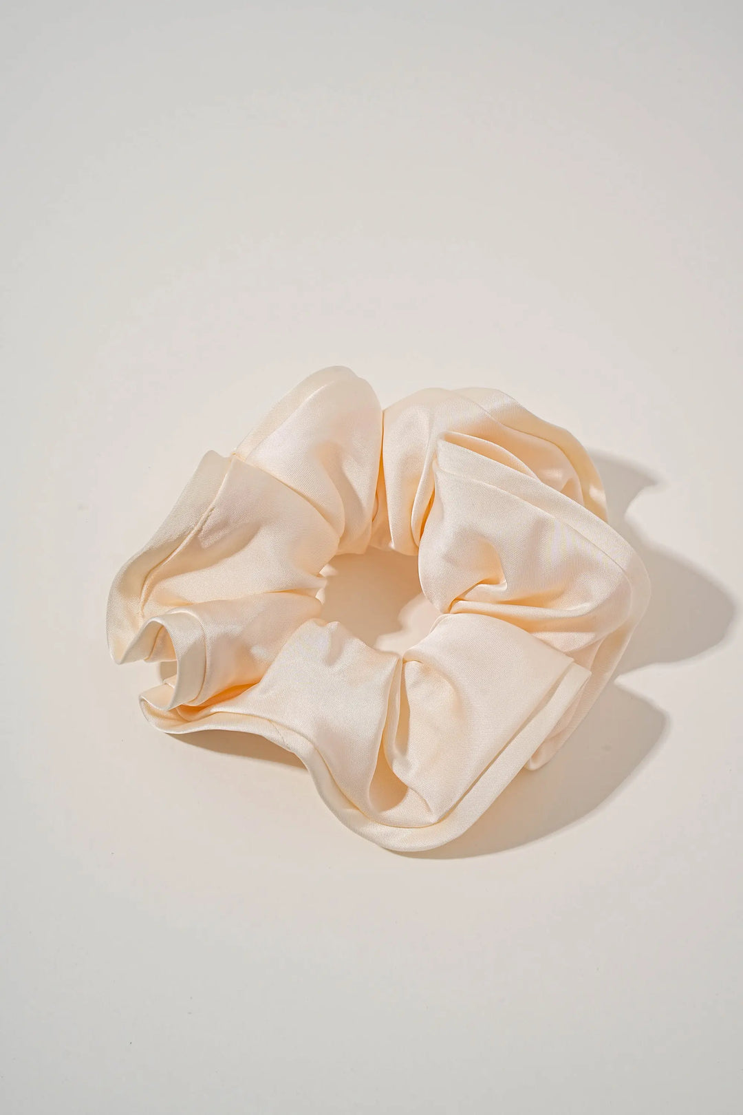 An image of a   Oversized Satin Cloud Scrunchie by  Mirra Masa