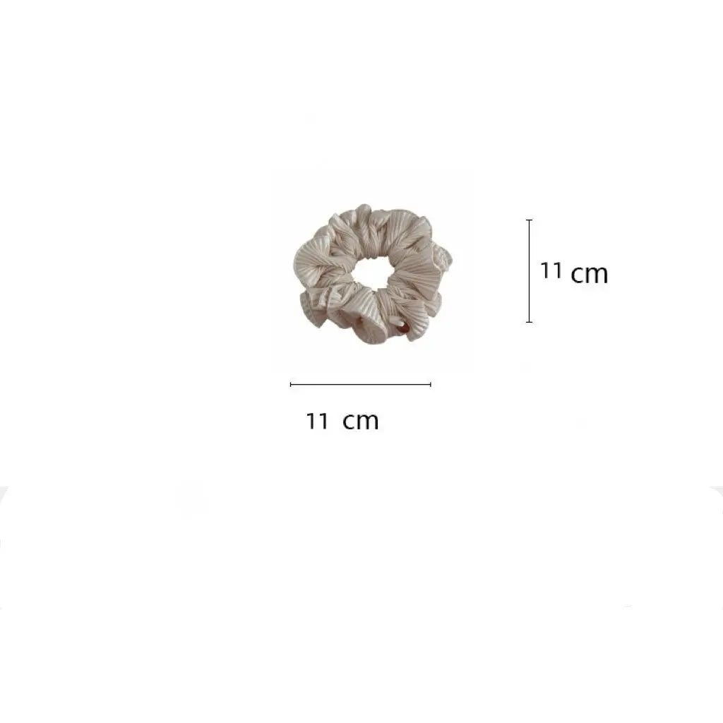 An image of a   Pleated Charm Scrunchie by  Mirra Masa