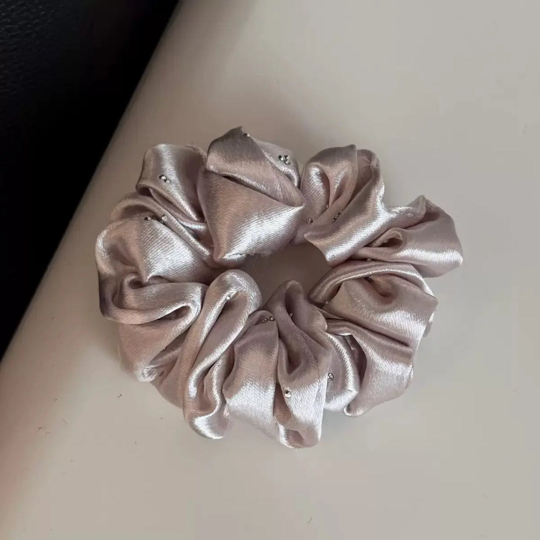 An image of a   Rhinestone Satin Scrunchie by  Mirra Masa