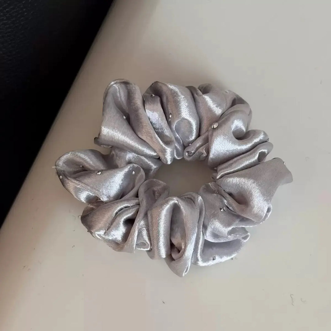 An image of a   Rhinestone Satin Scrunchie by  Mirra Masa