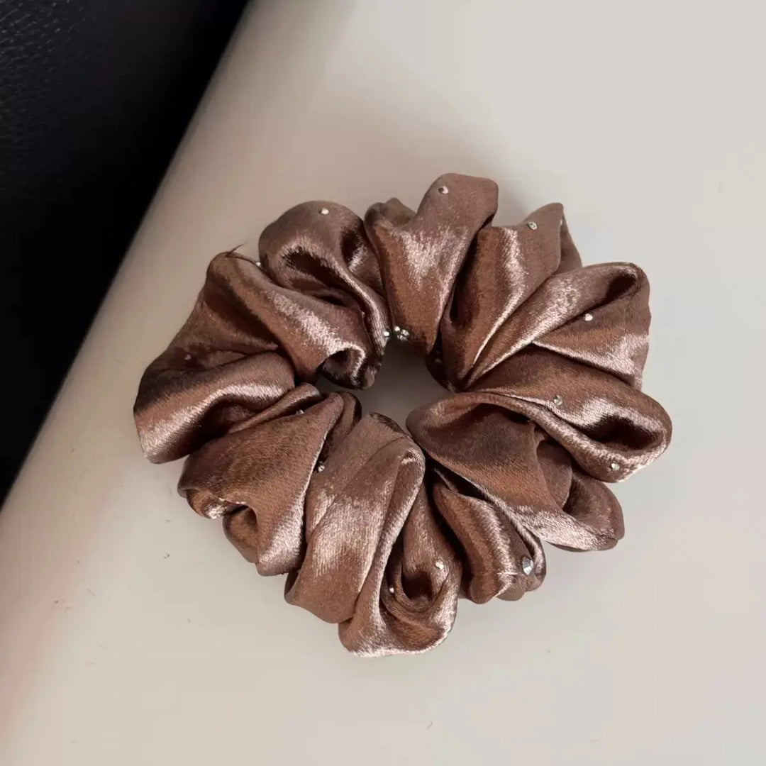 An image of a   Rhinestone Satin Scrunchie by  Mirra Masa