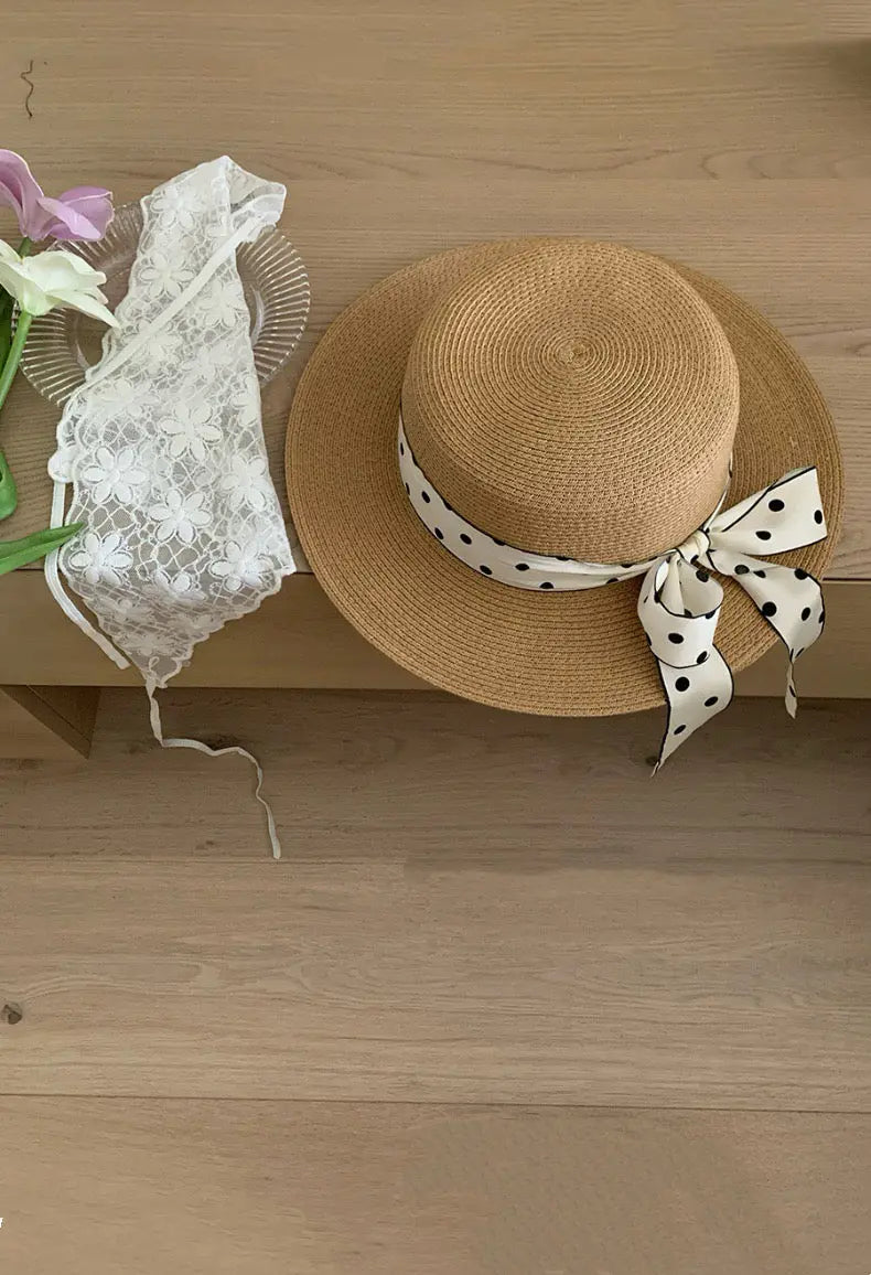 An image of a   Ribbon Bow Sun Hat by  Mirra Masa