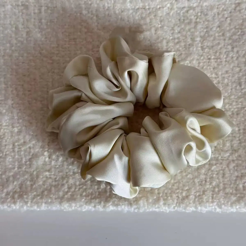 An image of a   Satin Ruched Scrunchie by  Mirra Masa