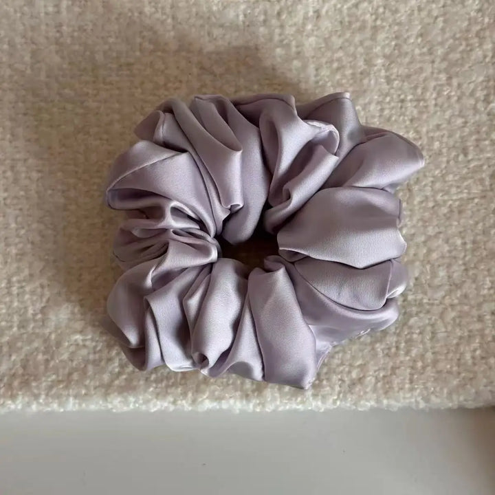 An image of a   Satin Ruched Scrunchie by  Mirra Masa