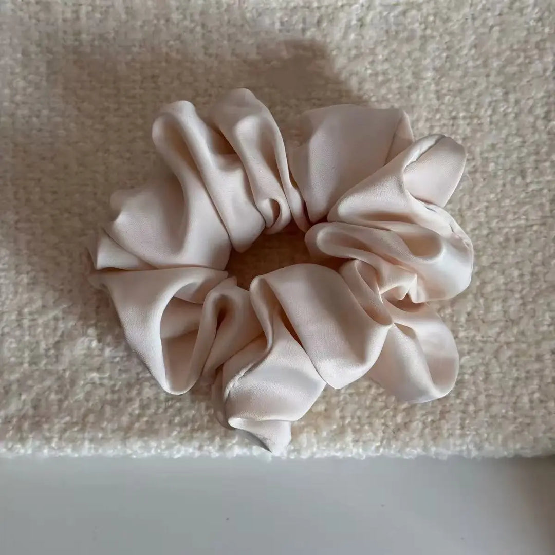 An image of a   Satin Ruched Scrunchie by  Mirra Masa